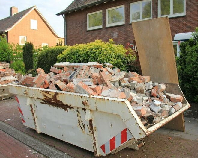 A 10 yard dumpster outside a residence in Dayton, OH filled with construction trash such as bricks, mortar, and wood